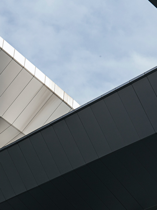 A building with angular lines and a blue sky in the background.