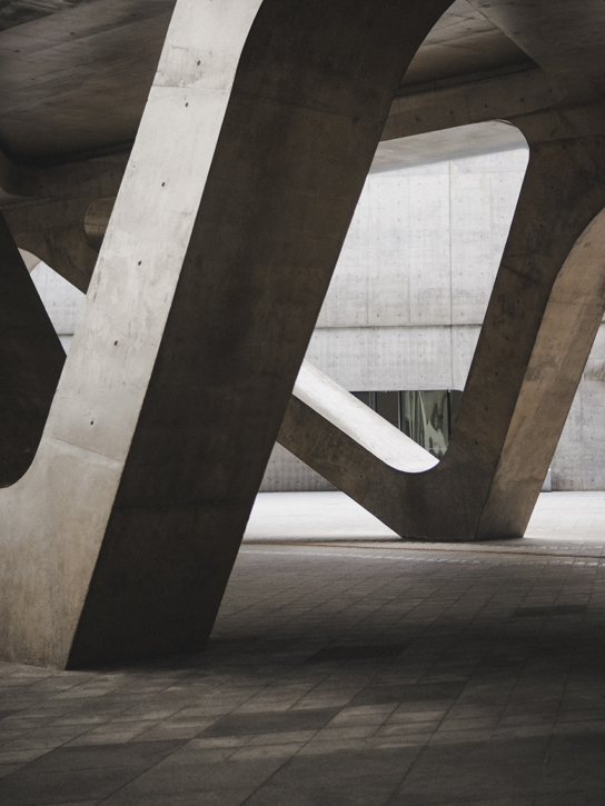 A concrete structure with curved arches and pillars.