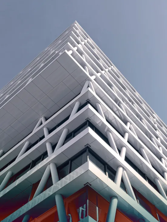 A modern building with a white exterior and a unique geometric design.