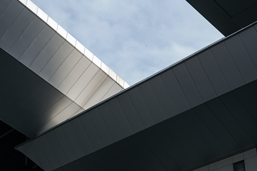 A building with angular lines and a blue sky in the background.