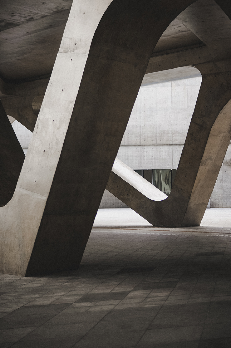 A concrete structure with curved arches and pillars.