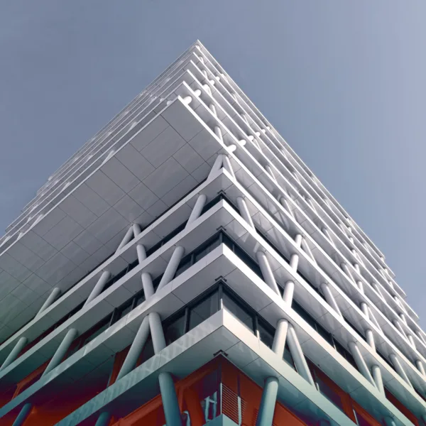 A modern building with a white exterior and a unique geometric design.